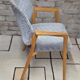 Vintage armchair from the 60s/70s in wood and grey fabric – with armrests.