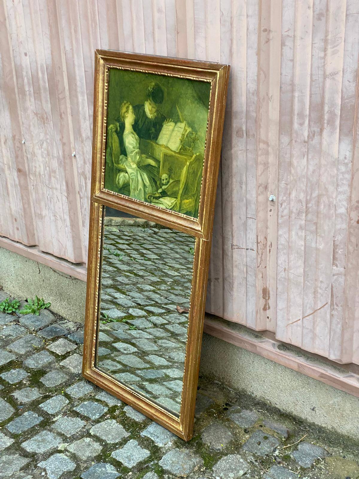 19th-century trumeau with mirror and music lesson canvas.
