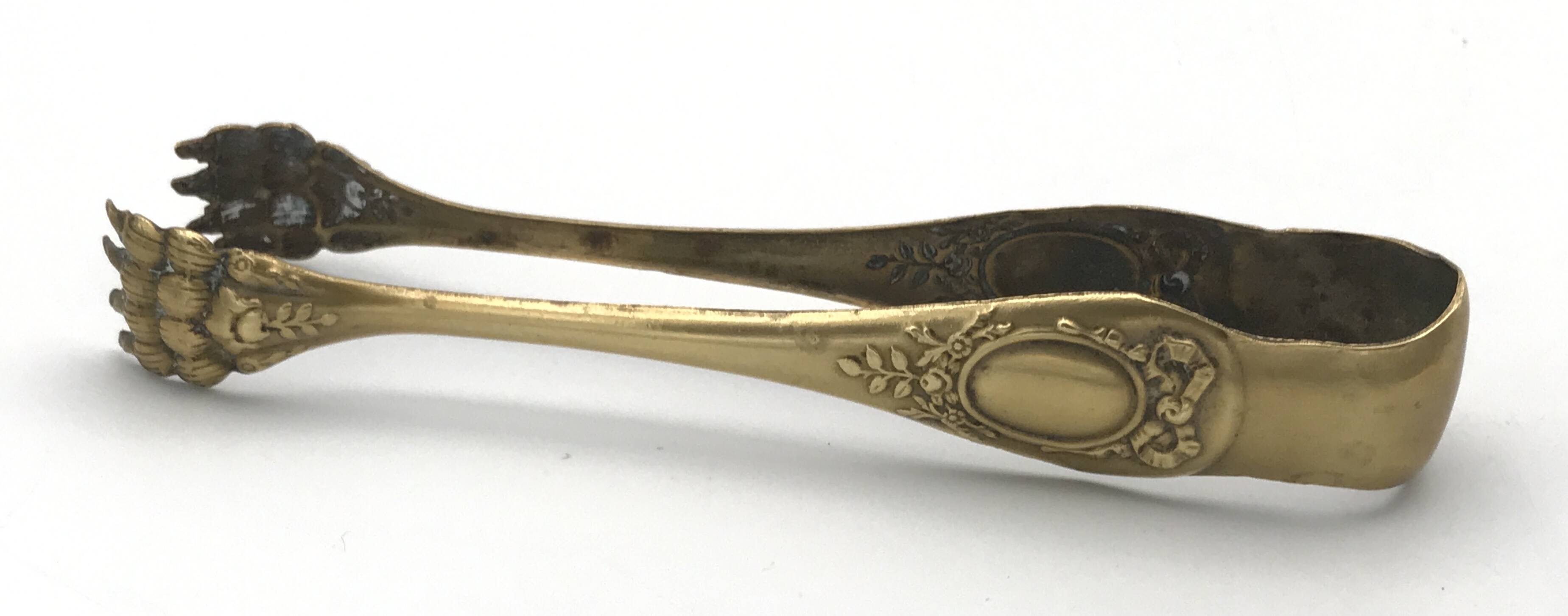 Sugar or ice cube tongs, gold star stamp with lion paw finish