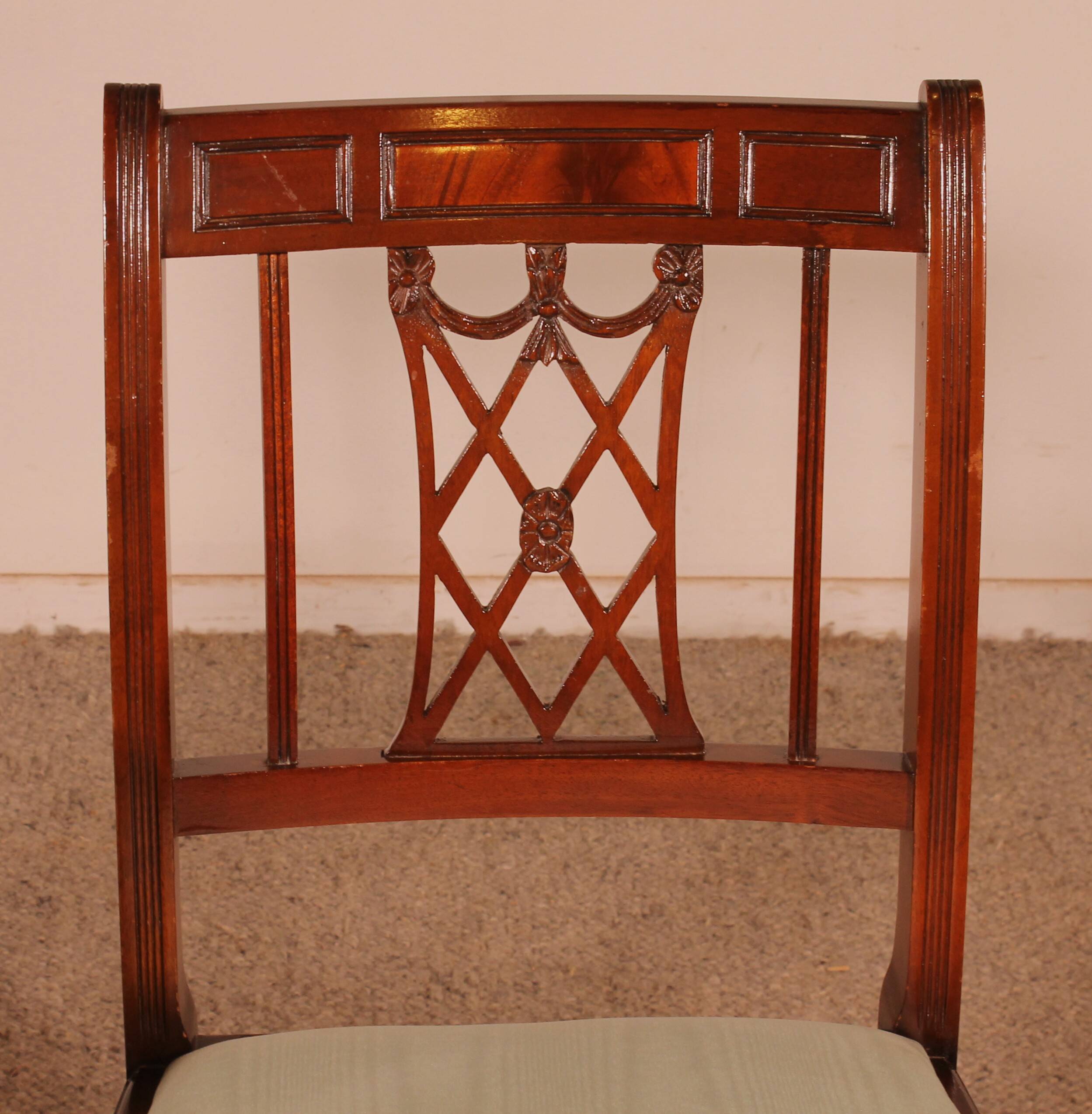 Set of 10 chairs and two mahogany armchairs in Hepplewhite style.