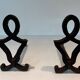 Pair of Modernist Andirons in Cast Iron with Stylised Figure Supports, by Ray