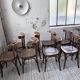 Set of 14 walnut bistro chairs.
