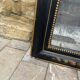 Antique Napoleon III mirror, black frame with hand-painted floral decoration – 19th century