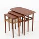 Rare set of three teak nesting tables with cane magazine rack / side tables / mid-century Danish modern design / 1950s / 1960s