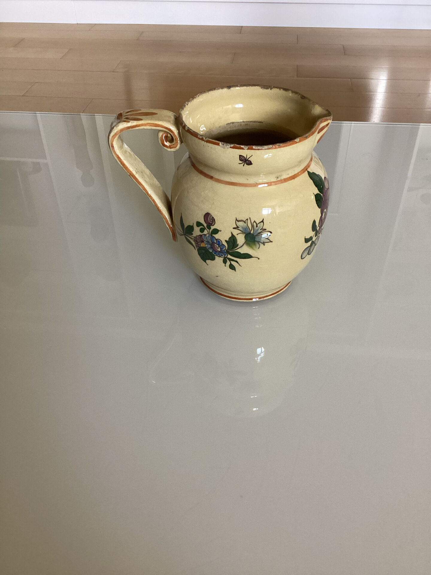 Old ceramic jug with floral decoration