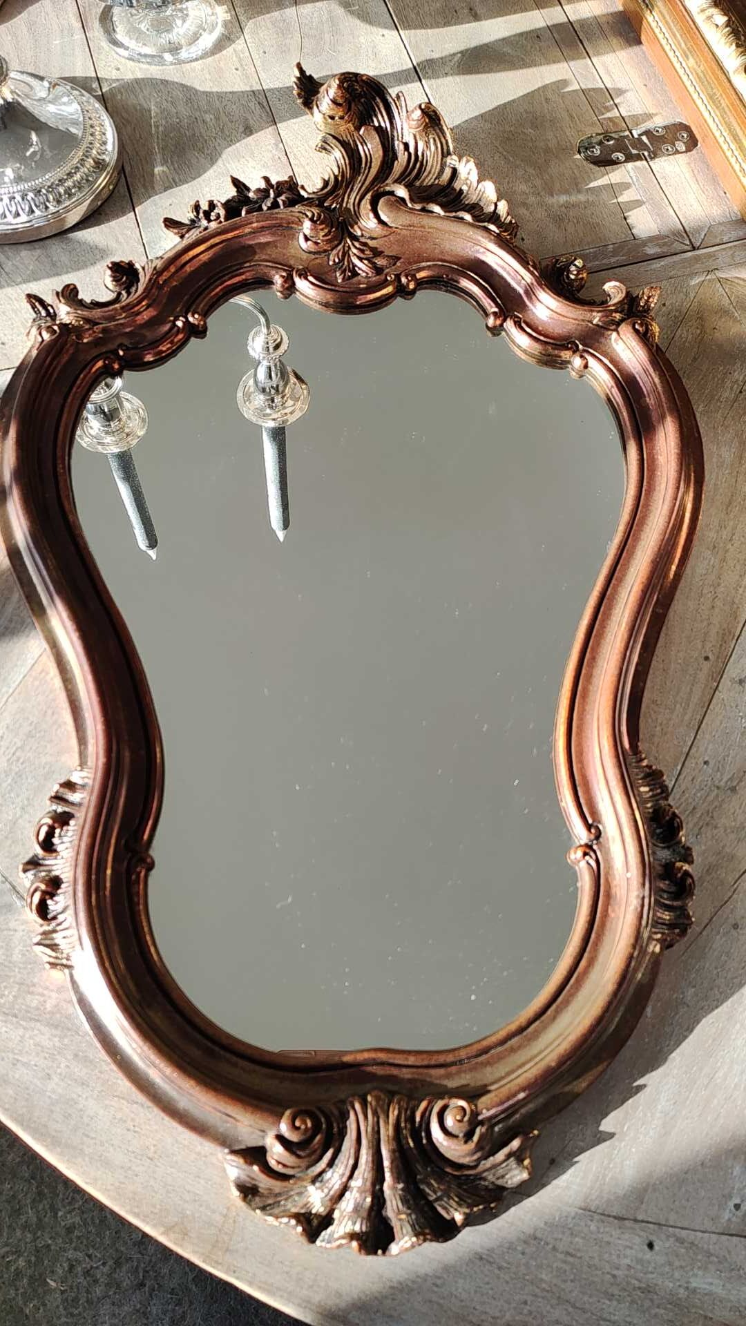 Pretty Baroque style mirror / Louis XV patinated with pink / golden copper reflections. Volutes, leafy shells