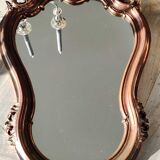 Pretty Baroque style mirror / Louis XV patinated with pink / golden copper reflections. Volutes, leafy shells