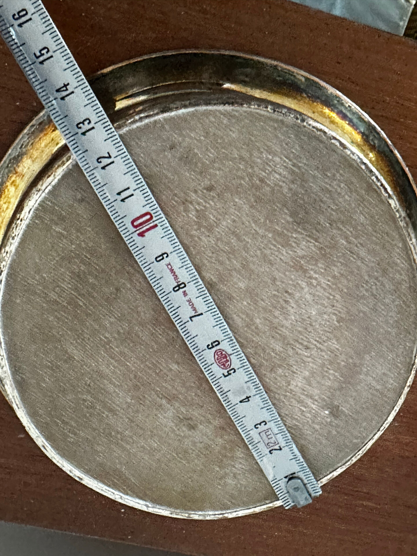 Antique silver-plated bottle coaster with floral decoration.