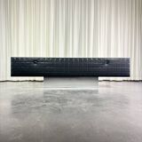 Modernist lowboard, faux leather, wood and stainless steel, 1960.