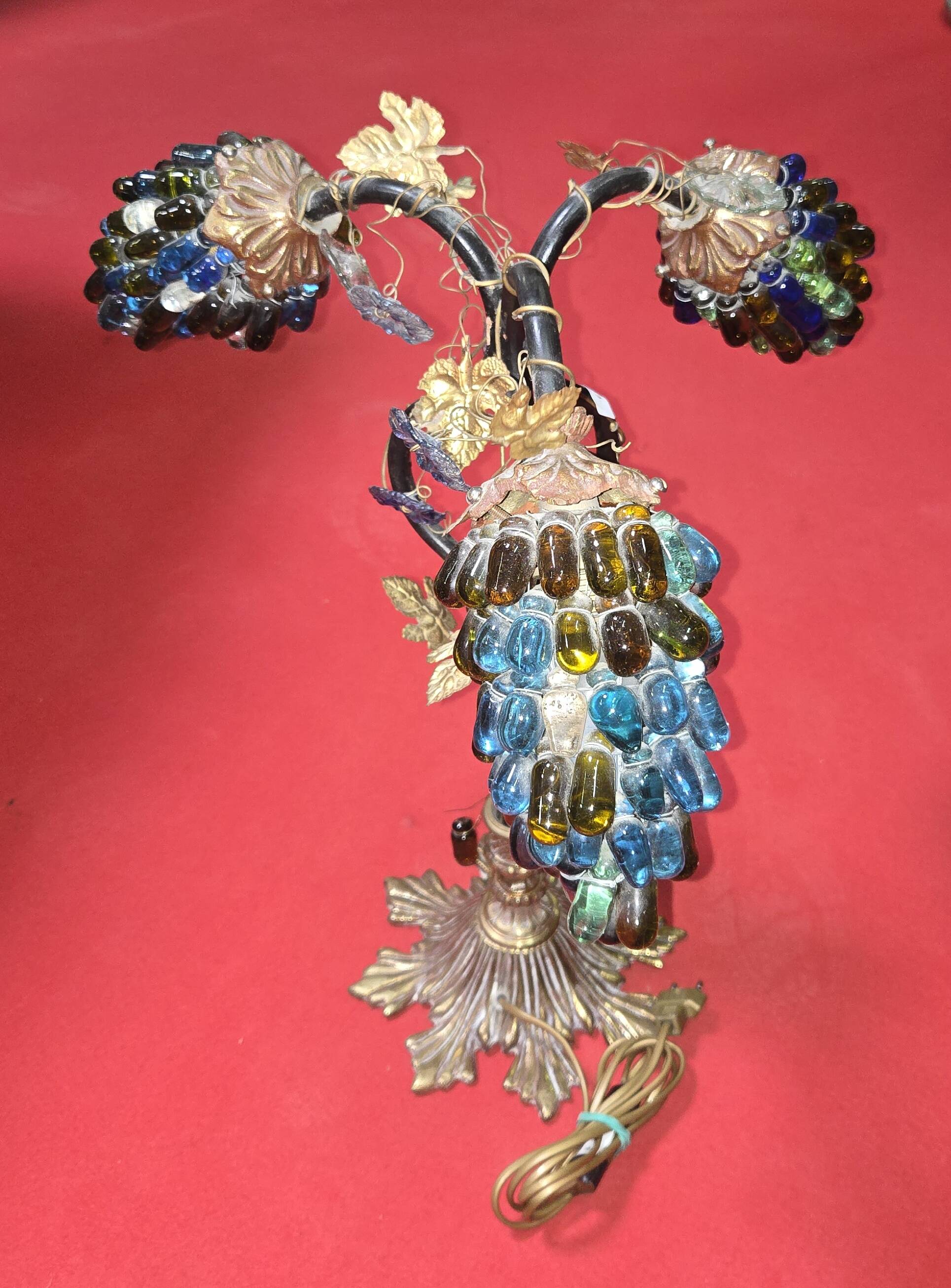 Decorative table lamp in the shape of coloured glass grape clusters.