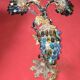 Decorative table lamp in the shape of coloured glass grape clusters.