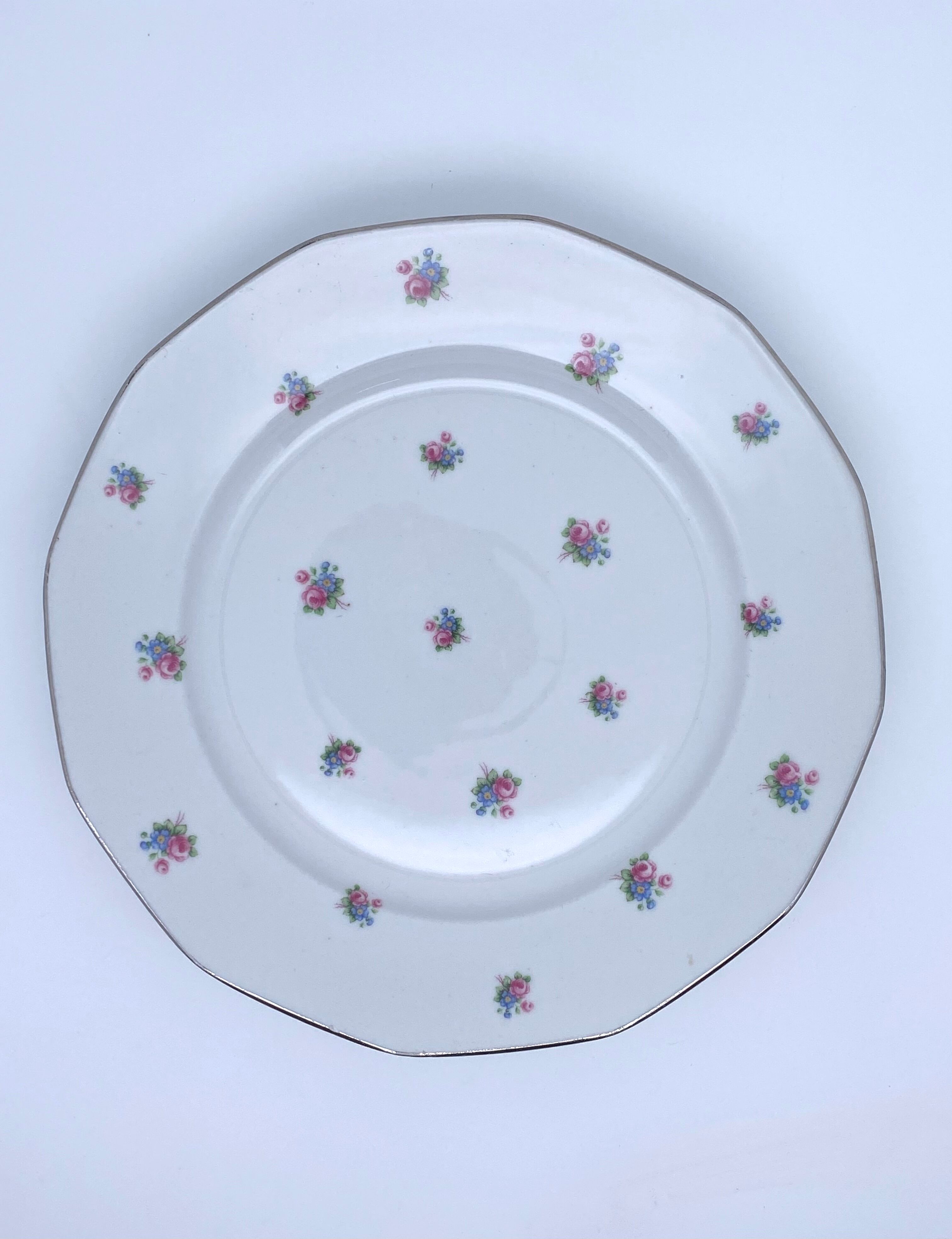 Porcelain serving dishes with small flowers and silver edging and