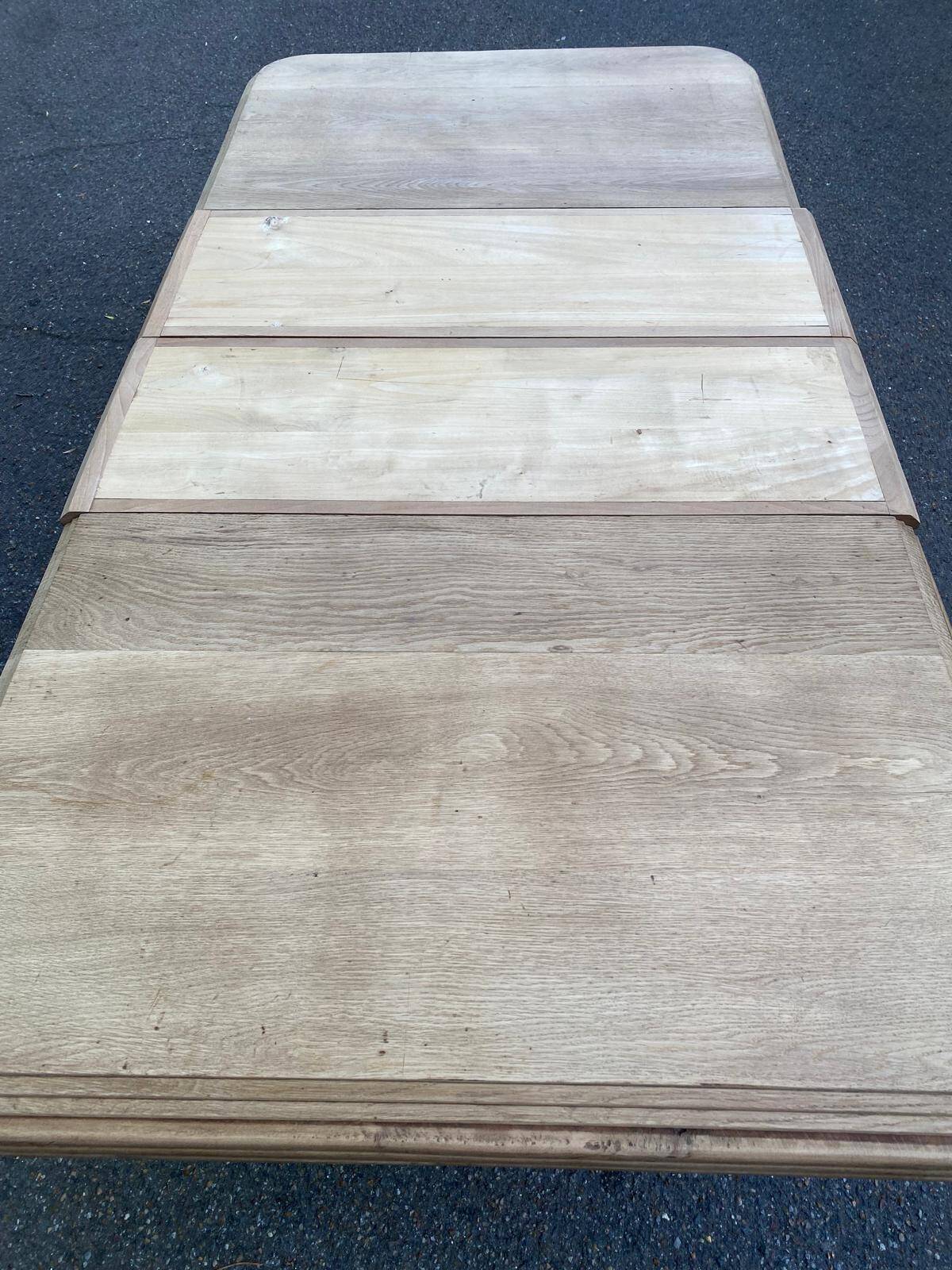 Art Deco dining table with a central pedestal, stripped in solid oak, with 2 extensions.