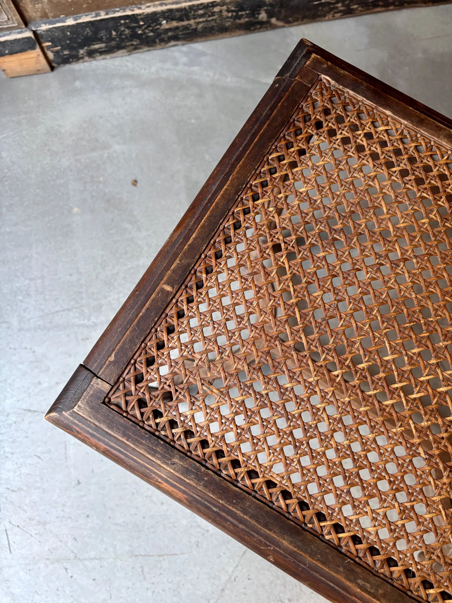 Stool, small wooden piano bench with carved details and caning.
