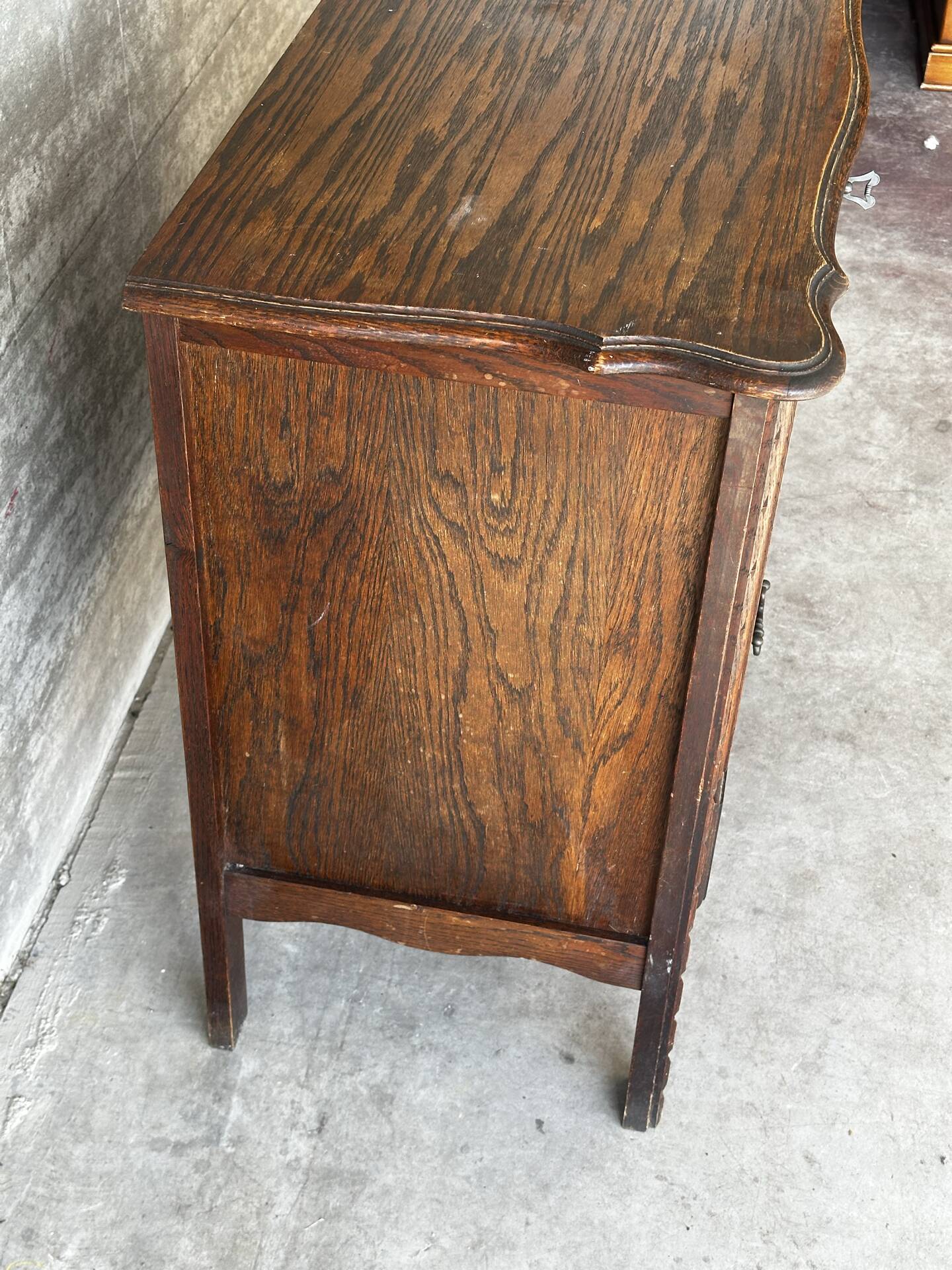 Small storage cabinet in carved oak – circa 1930