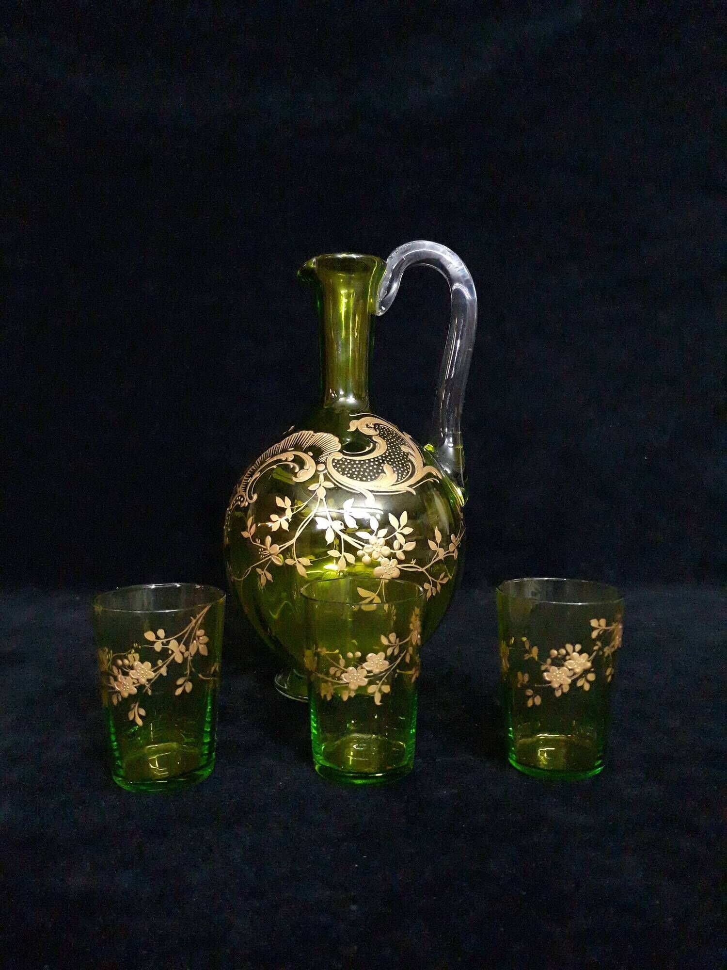 Small carafe and green glass drop glasses with rococo golden emailed decor