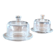 2 transparent glass butter dishes accompanied by their matching cloches.