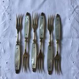 Old brass forks and knives and mother-of-pearl handle