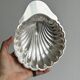Old metal plate in the shape of a shell.