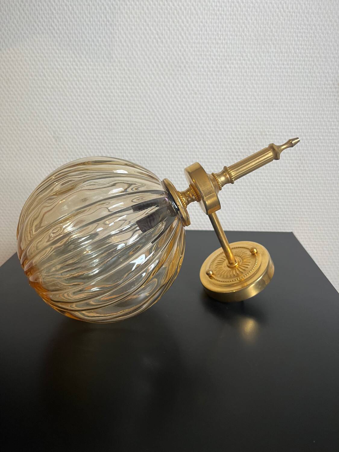 Brass wall light and bubbled glass globe