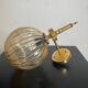 Brass wall light and bubbled glass globe
