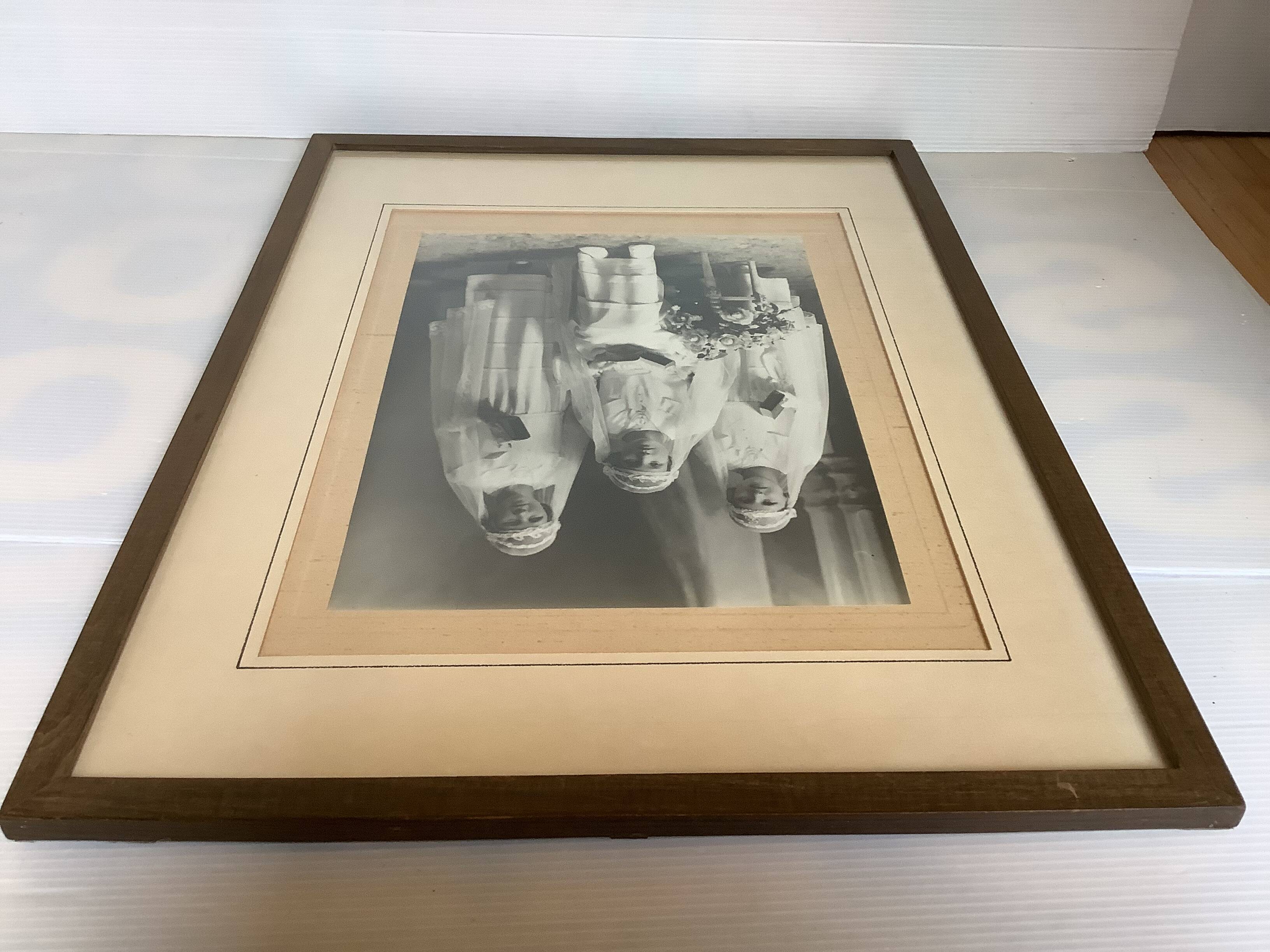 Large frame old photograph of a trio of communicants.