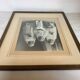 Large frame old photograph of a trio of communicants.