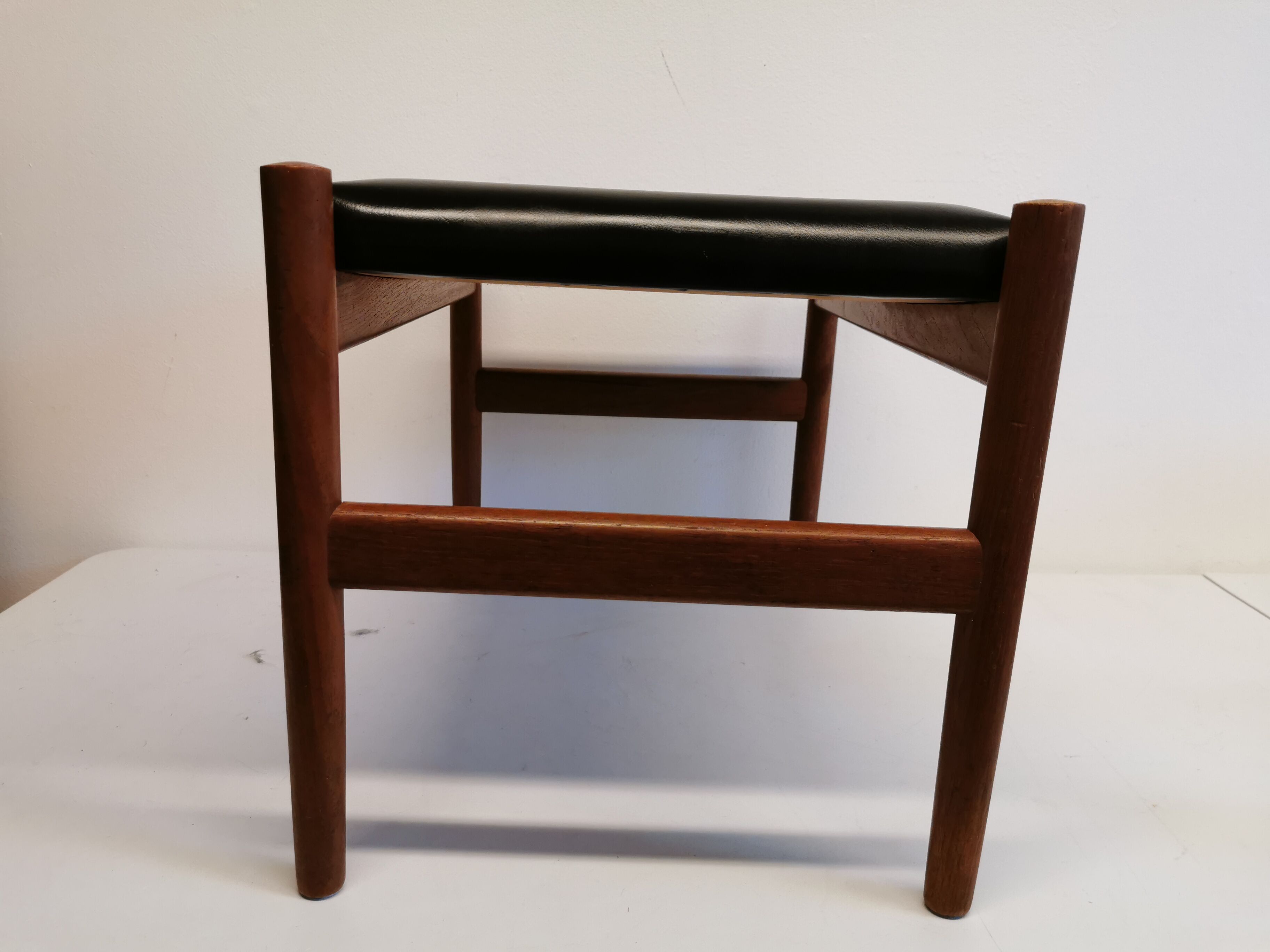 Danish designed footstool, in teak and black skai. Made at Spøttrup furniture factory in the 1960s.