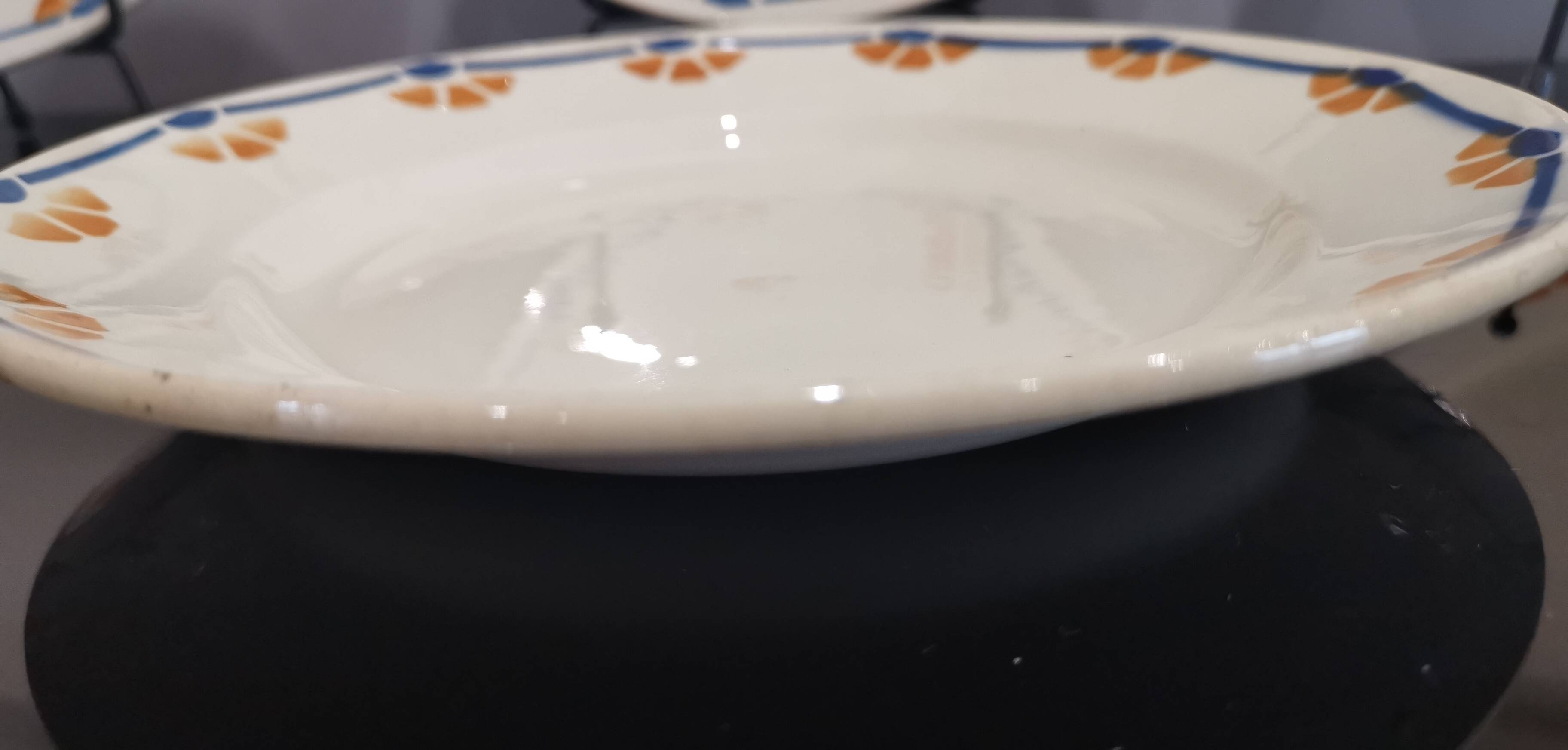 Old semi-deep plates in Terre de fer earthenware