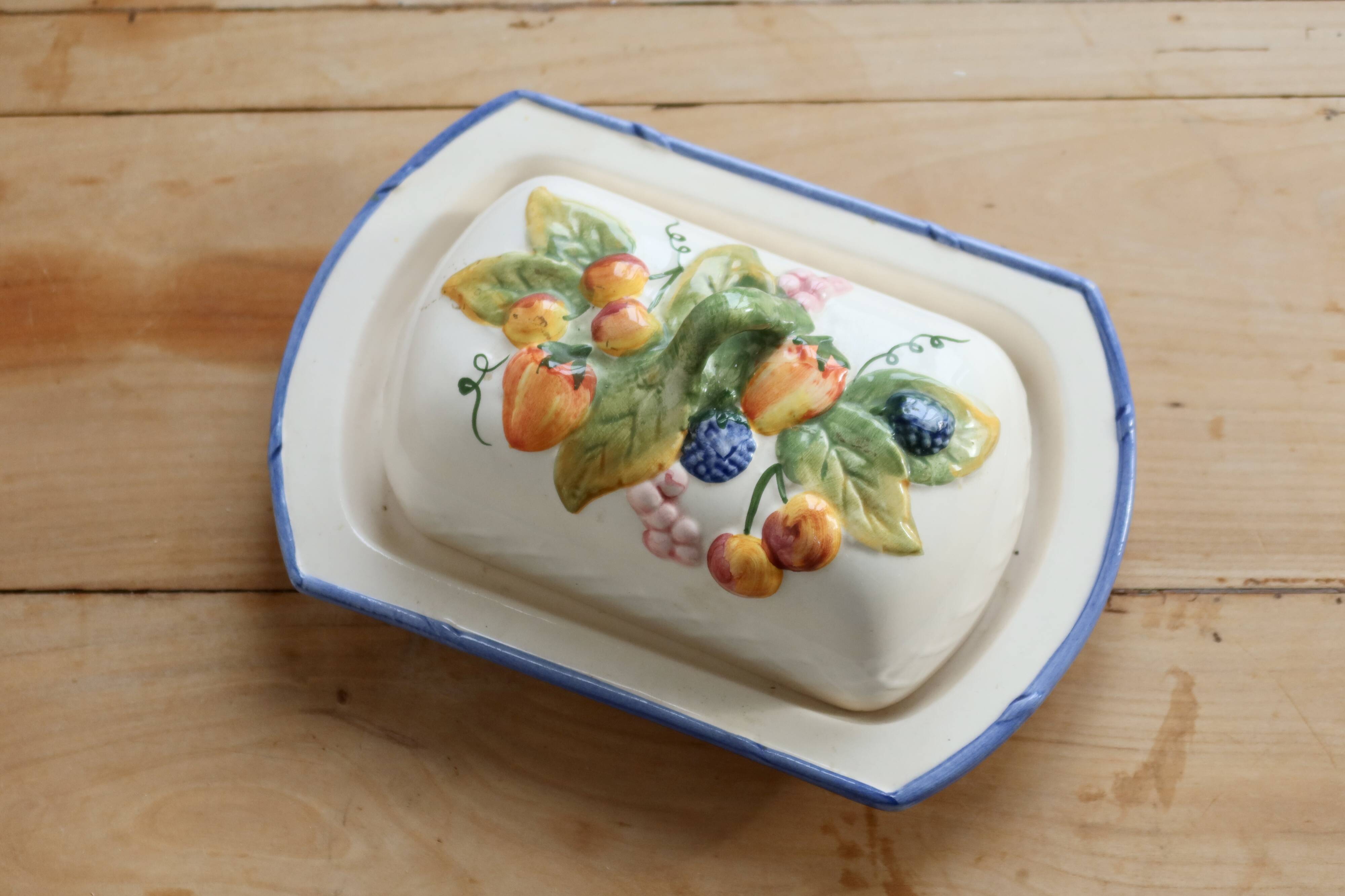 Large vintage faience butter dish with slip decoration – Fruit design