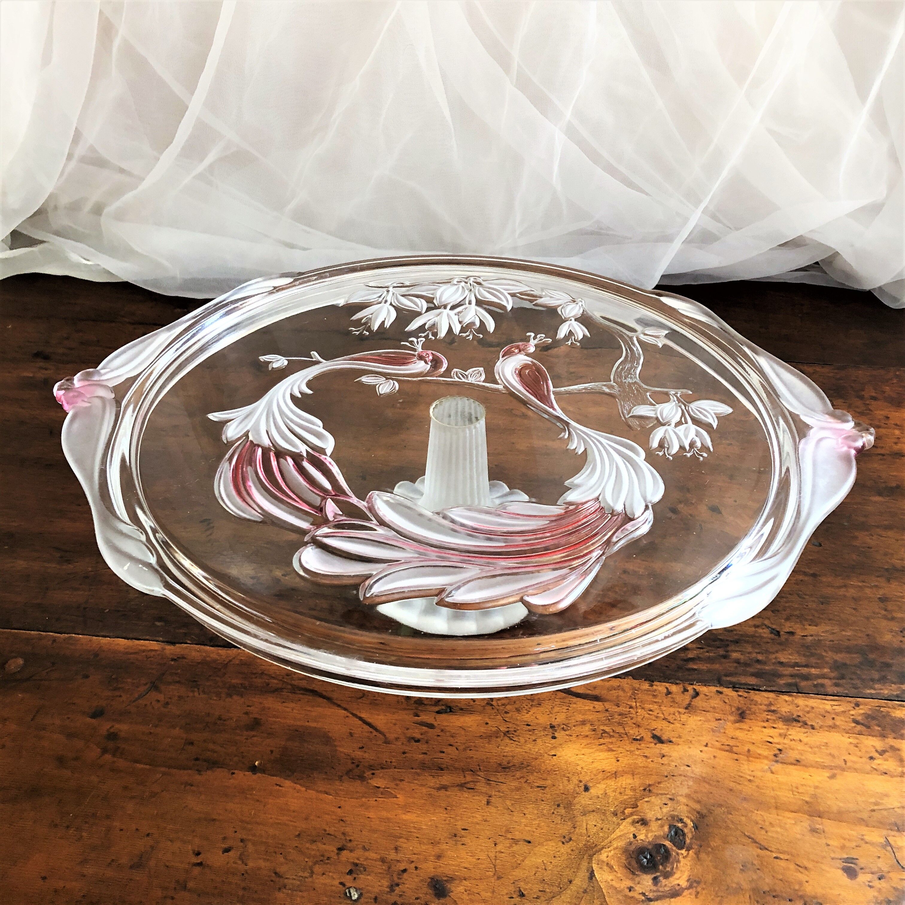 Large pie dish cakes on pedestal decorated with peacocks