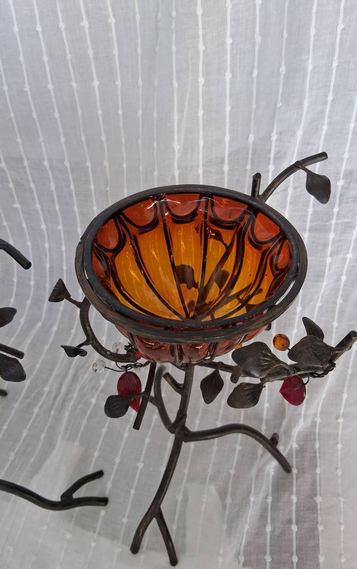 Pair of Art Deco style candle holders in wrought iron and amber blown glass.