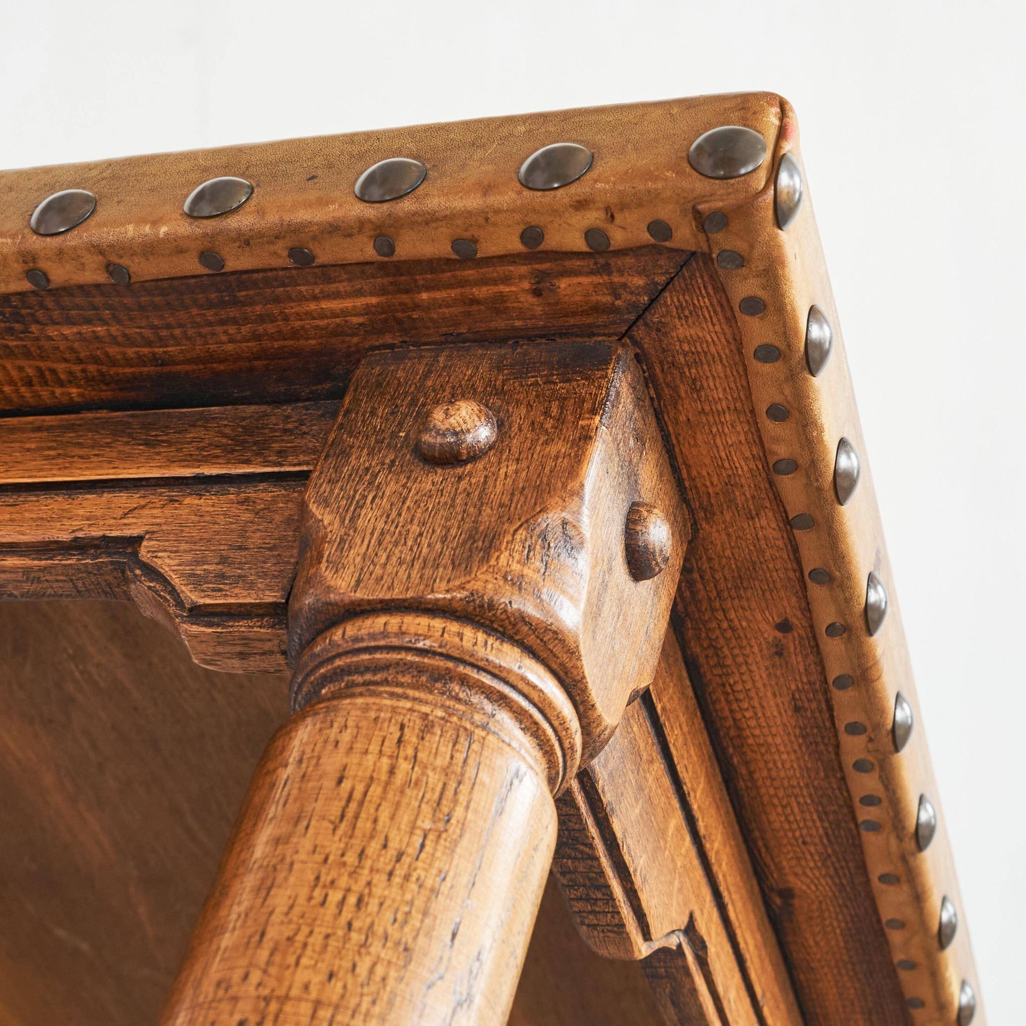 Brutalist coffee table in solid oak, metal, and patinated leather, 1940s.