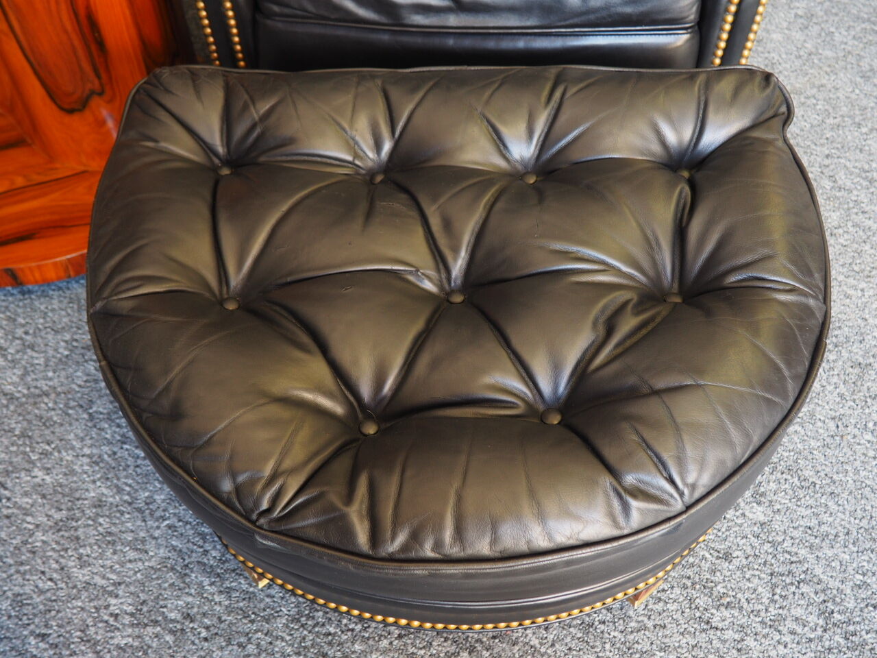 Chesterfield style leather armchair & footstool by Hancock & Moore