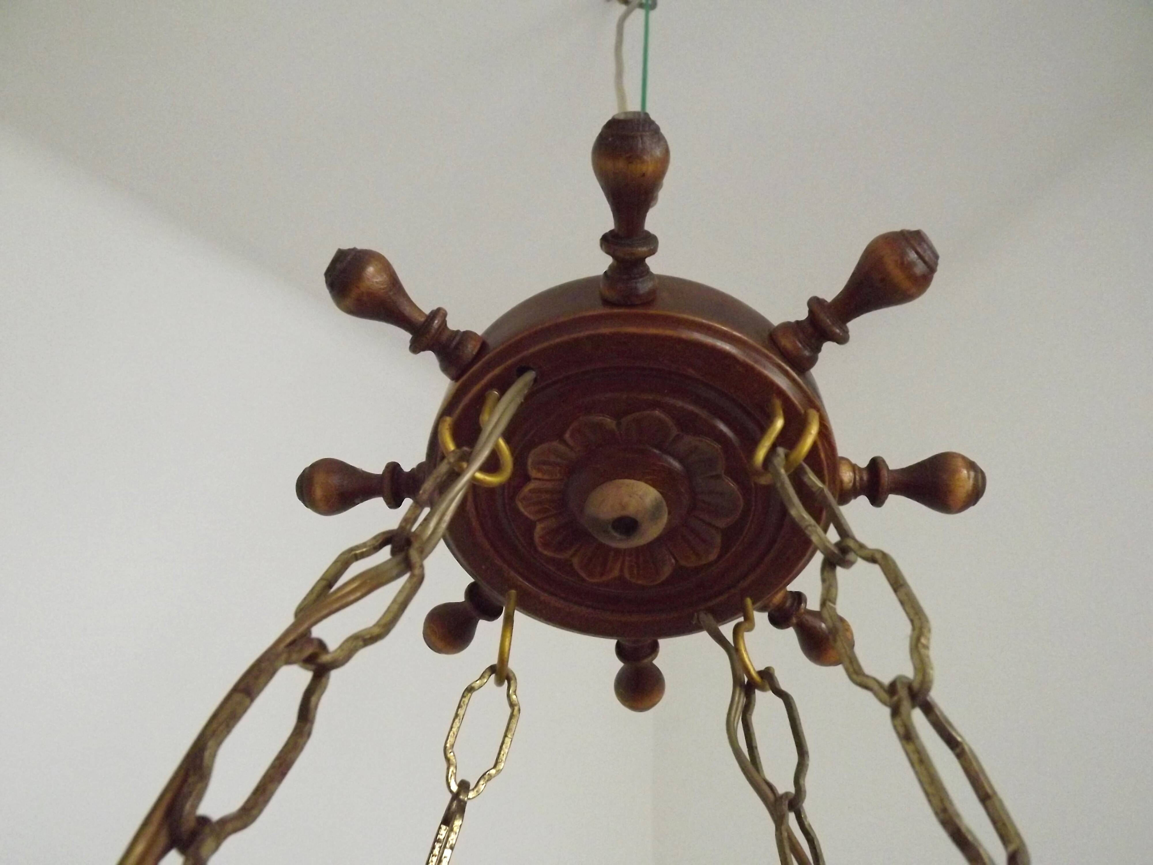 French vintage Breton chandelier with hand-carved figures, well, and lantern lights.
