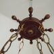 French vintage Breton chandelier with hand-carved figures, well, and lantern lights.