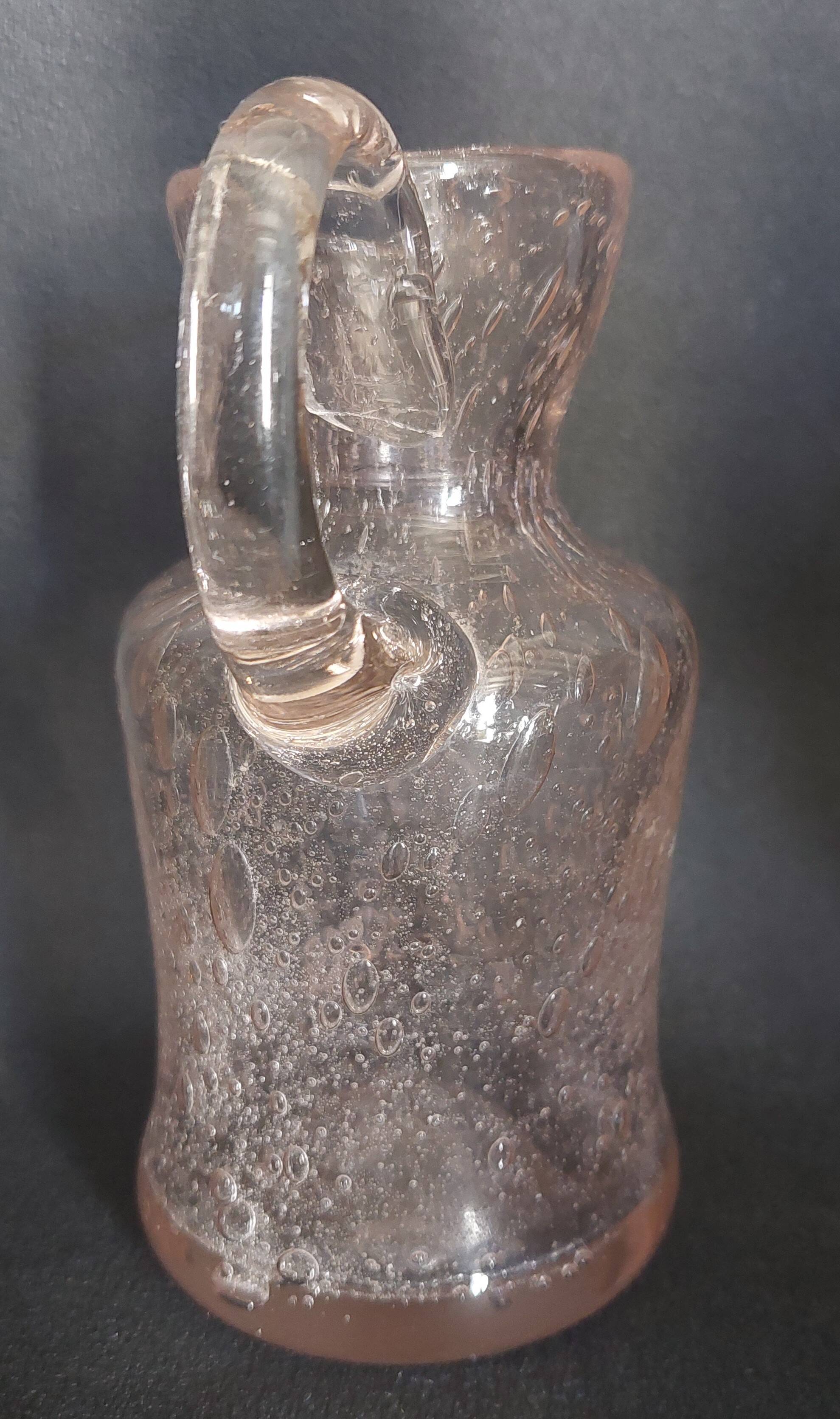 Small blown glass pitcher with bubbles from the 20th century.