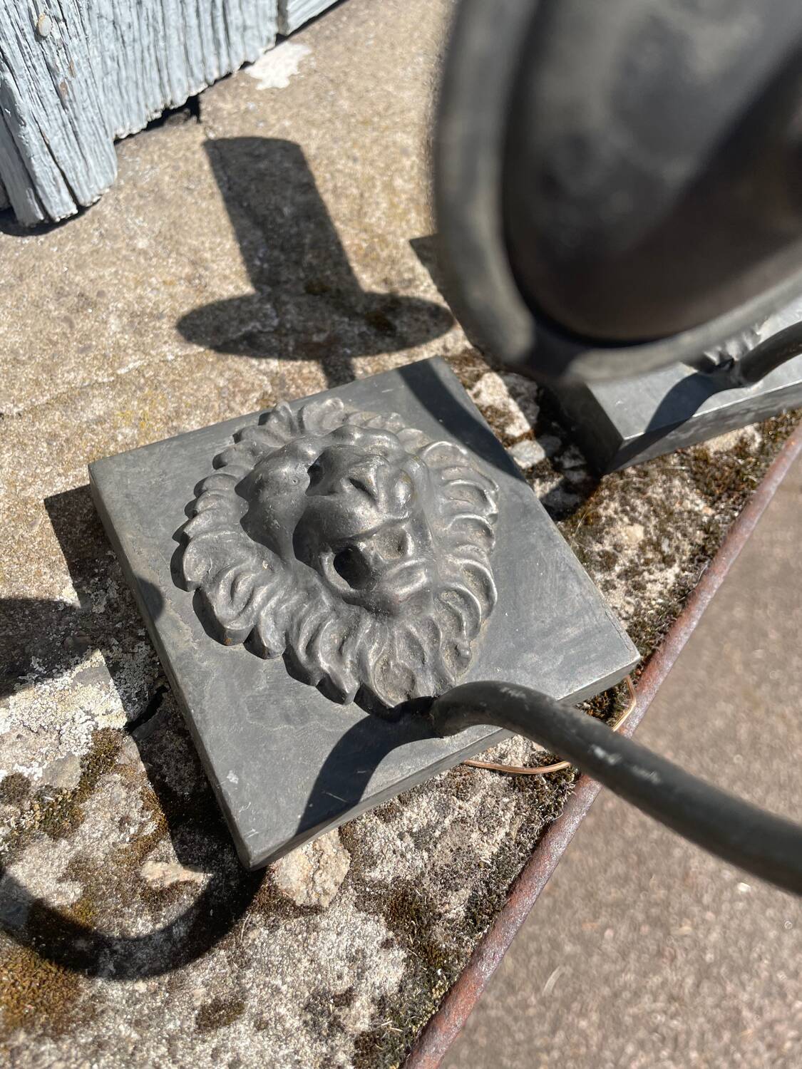 Two lion head wall sconces in tin.