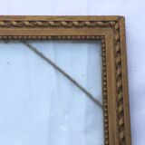 Gilded wooden frame and its glass