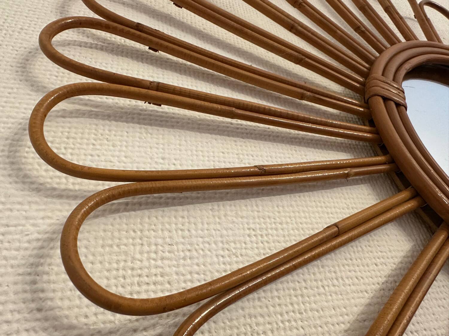 Old vintage asymmetrical round rattan mirror