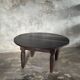 Antique round coffee table in Indonesian teak with turned legs.