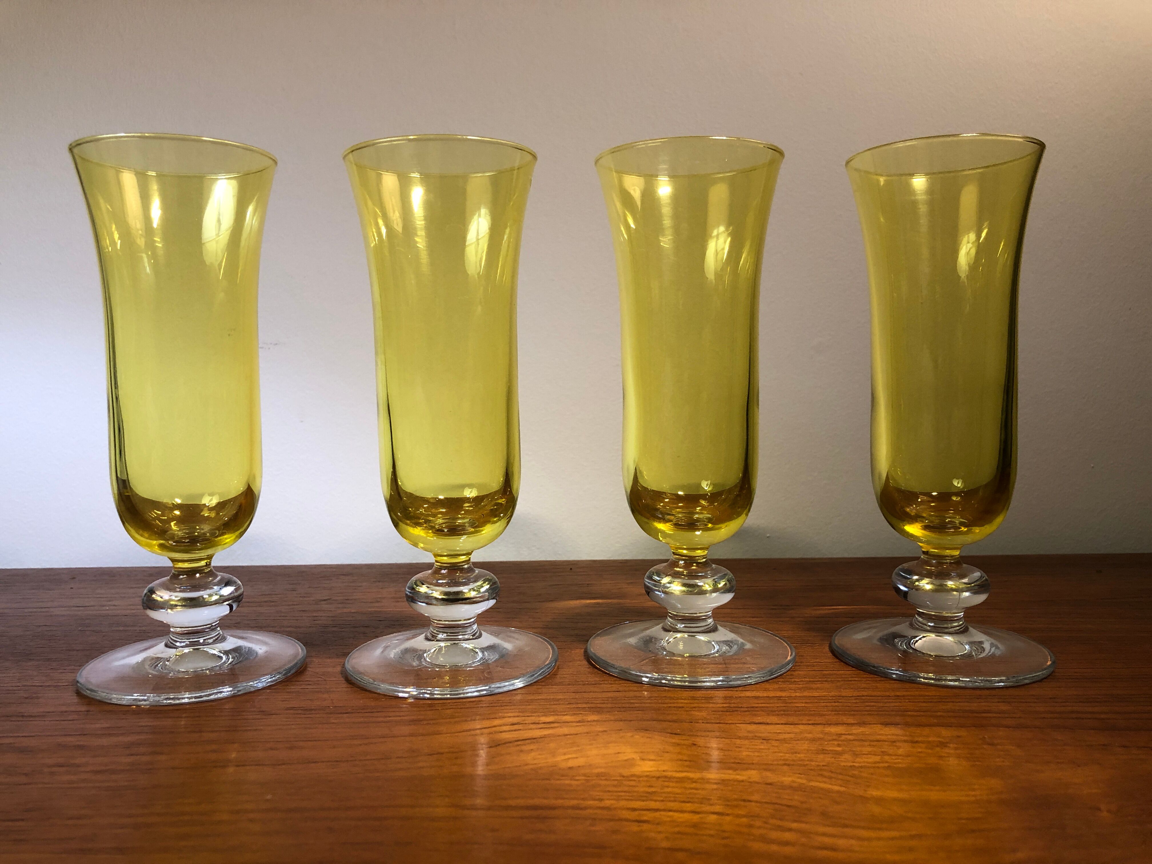 Large transparent yellow champagne flutes