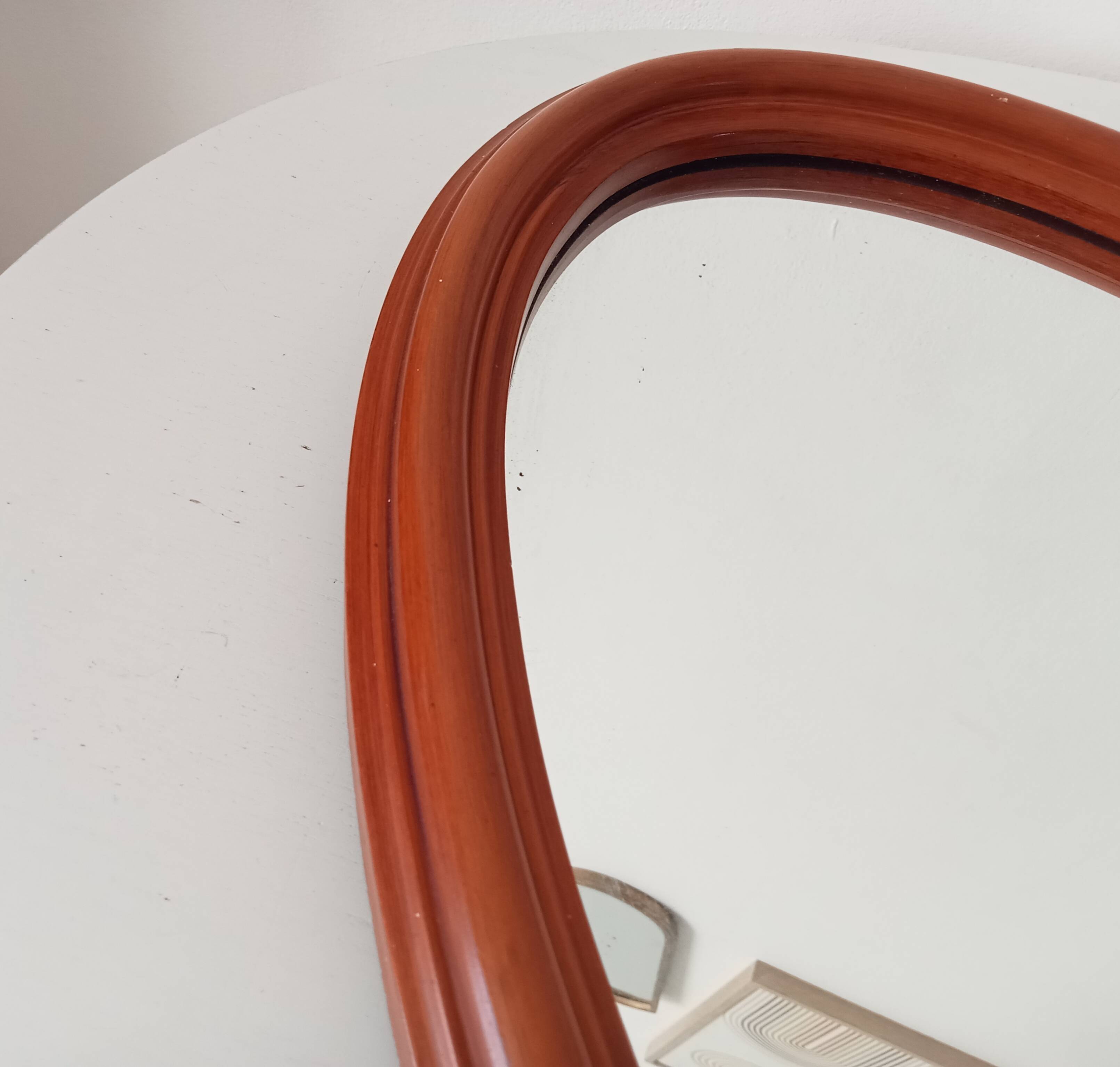 Vintage oval wooden mirror "caramel" from the 1960s.