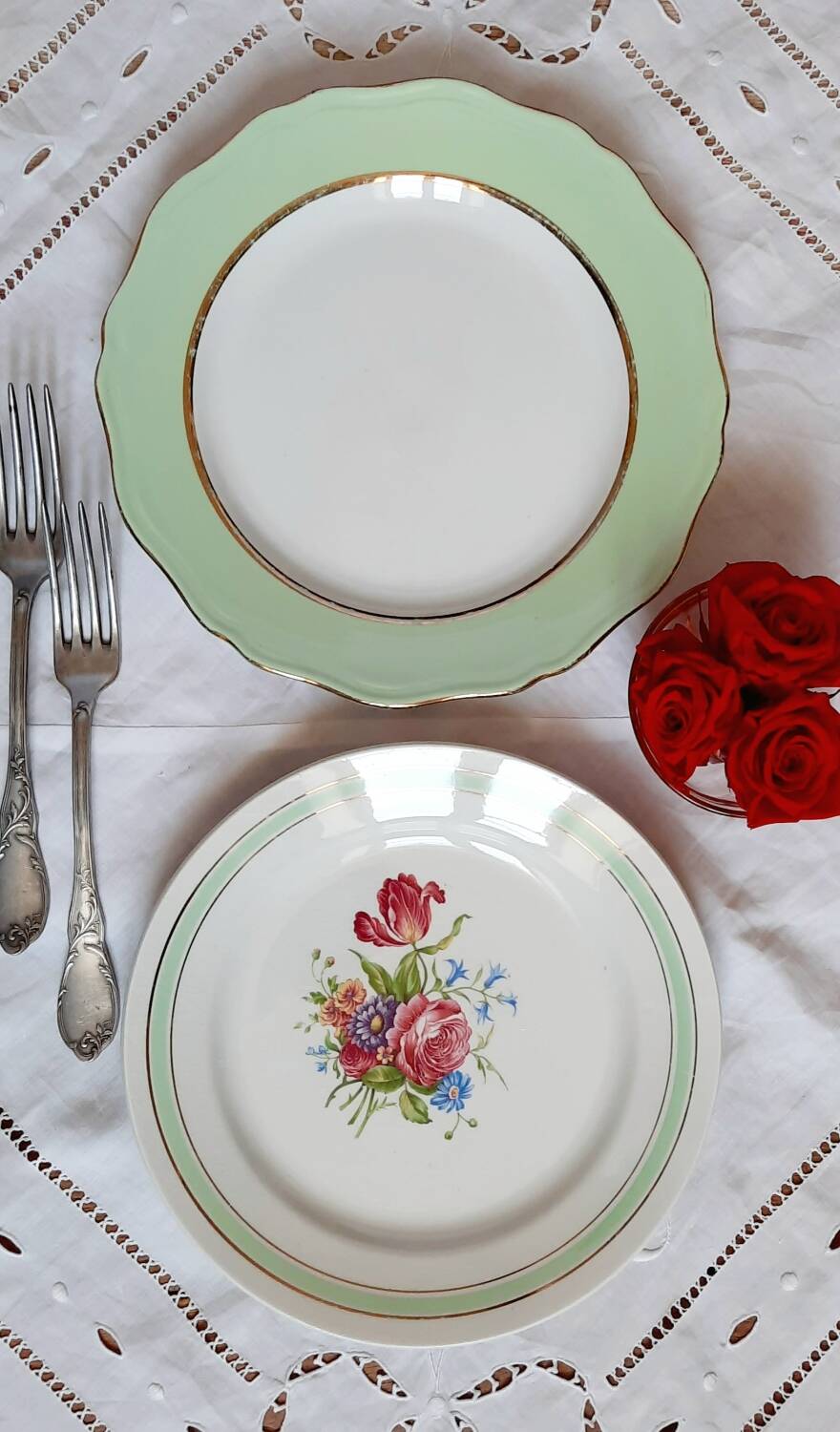 Old mismatched earthenware dinner plates with gold accompanied by a dish
