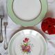 Old mismatched earthenware dinner plates with gold accompanied by a dish