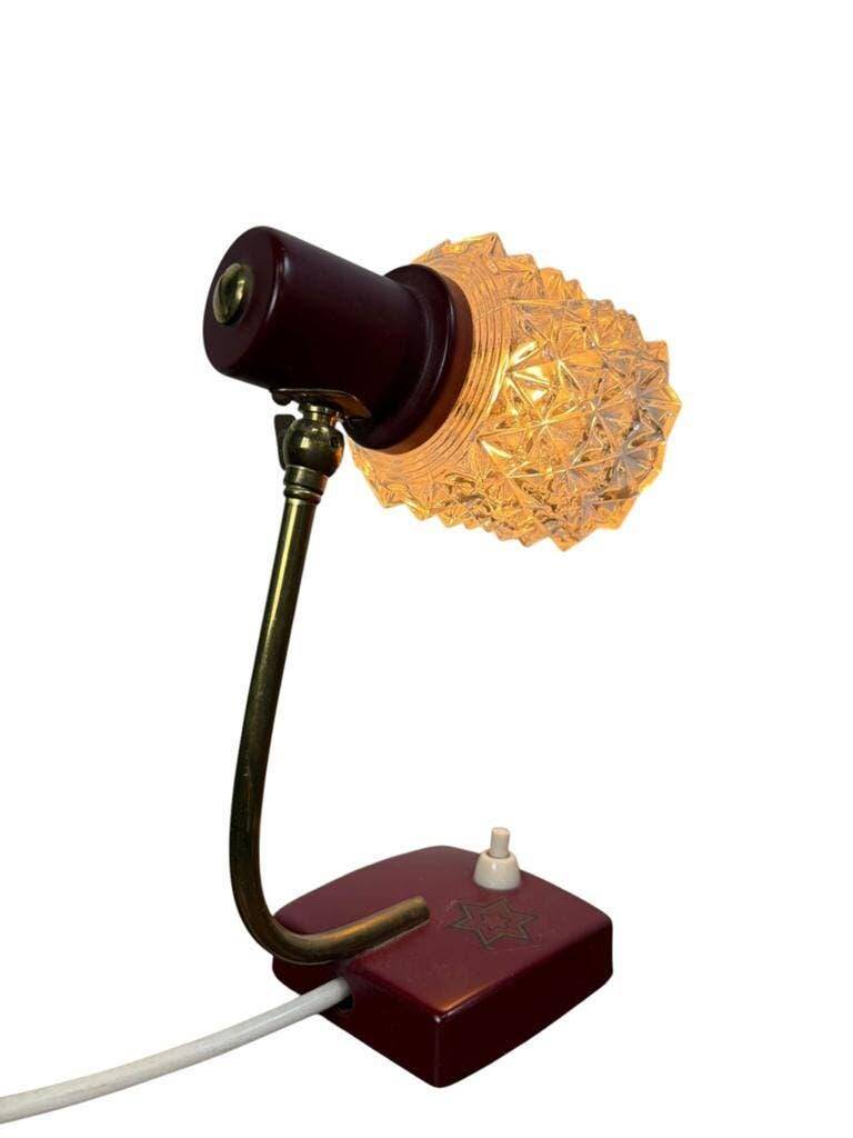 Vintage burgundy table lamp with glass shade.