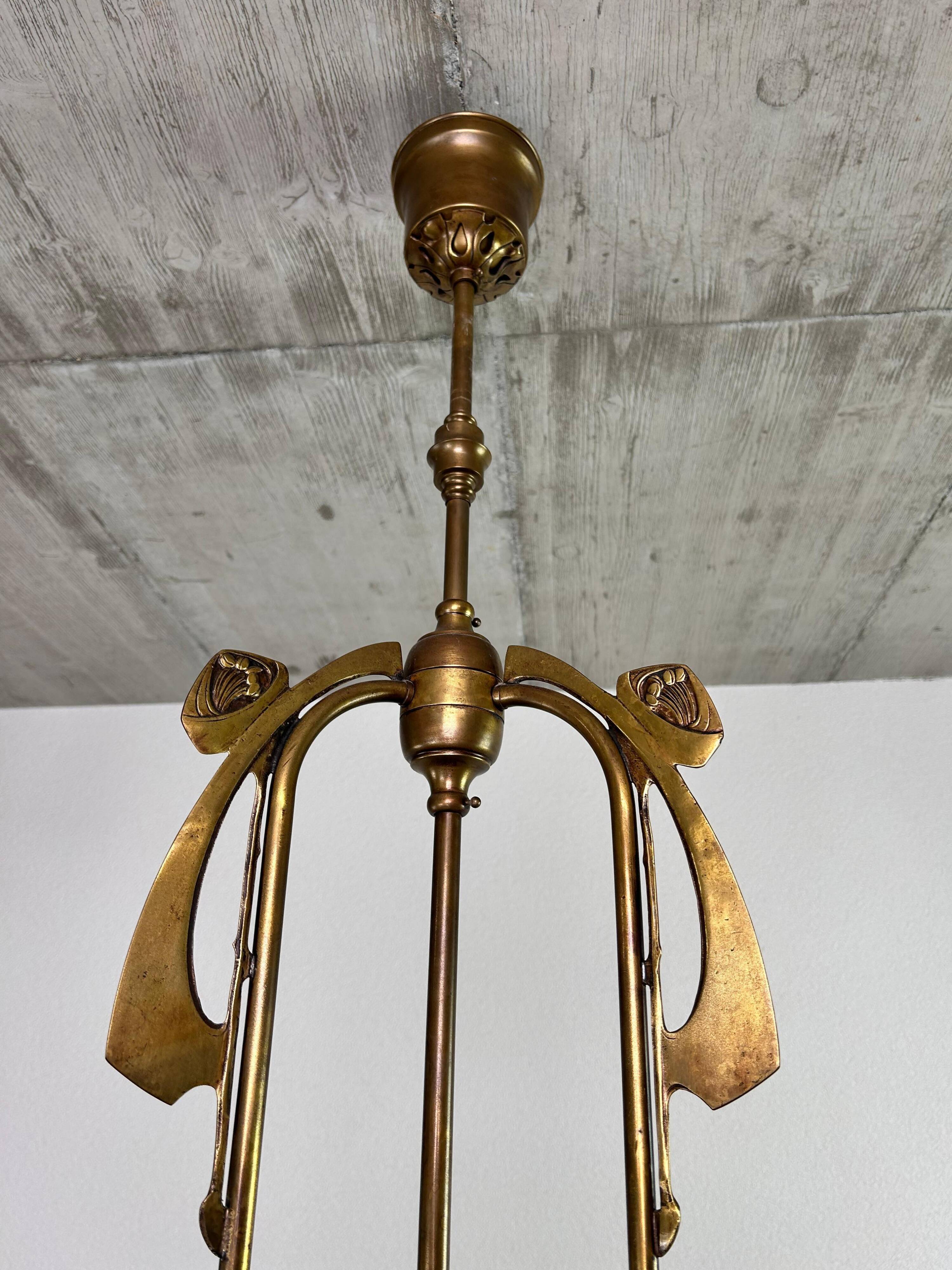 Art Nouveau chandelier with three arms and opalescent iridescent glass.