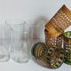 Four long drink glasses in vintage woven rattan cases