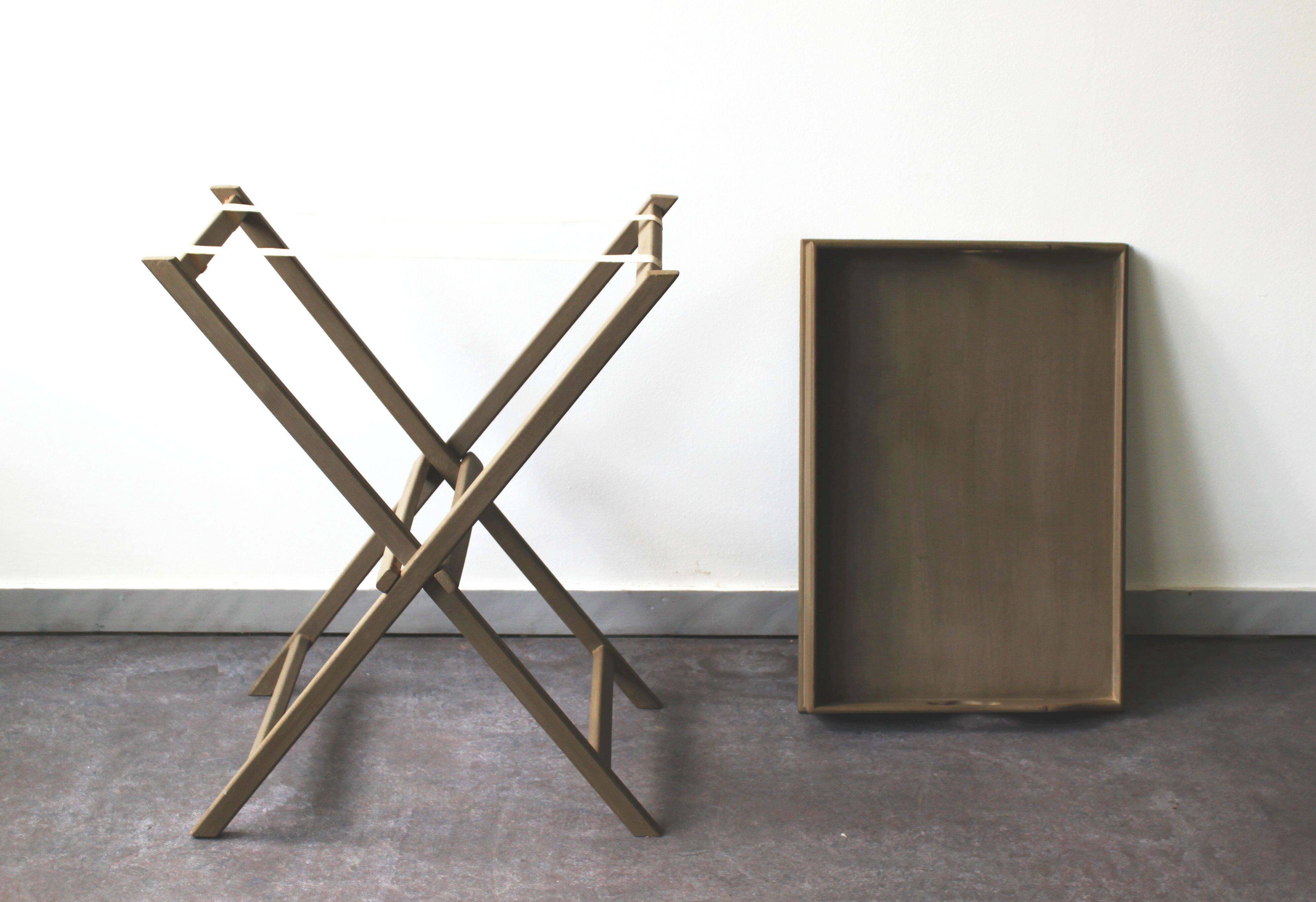 Folding and removable service tray in taupe-painted wood.