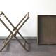 Folding and removable service tray in taupe-painted wood.
